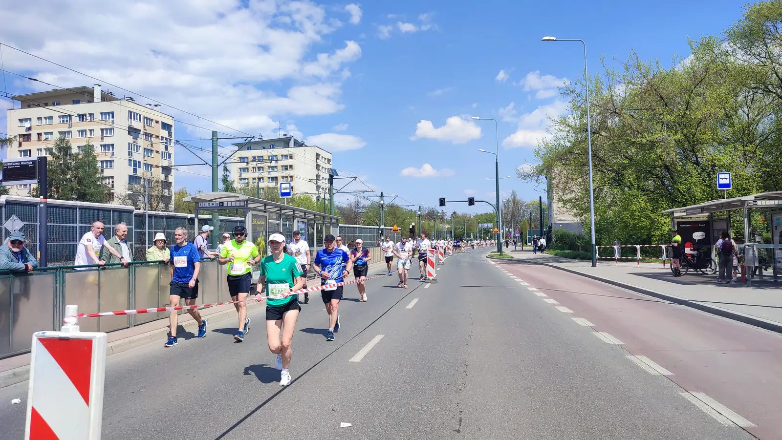 Biegacze na alei Jana Pawła II w Krakowie podczas Maratonu Cracovia — zdjęcie ilustracyjne biegu ulicznego