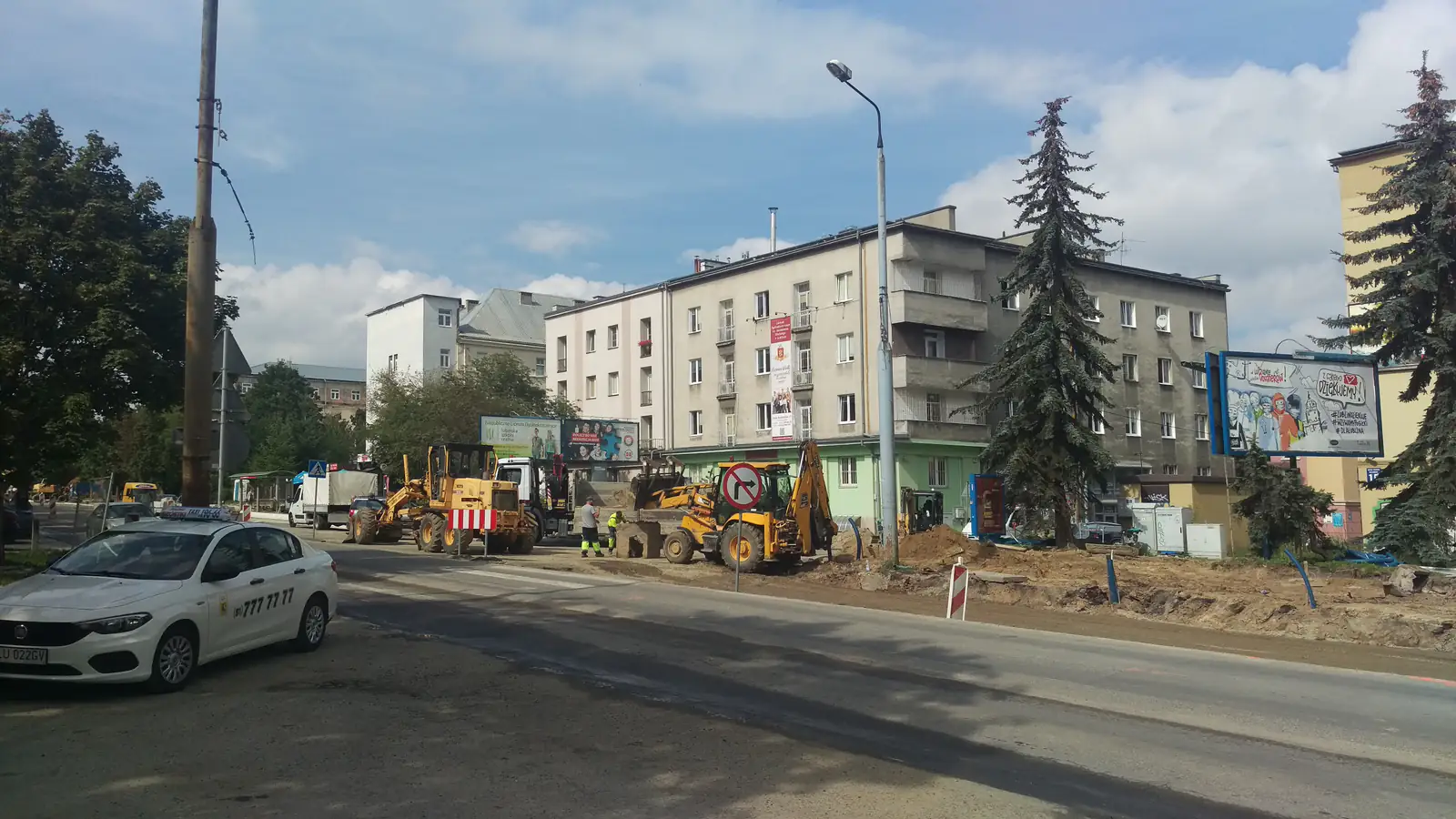 Przebudowa ulicy — koparka i prace drogowe w mieście (zdjęcie ilustracyjne).